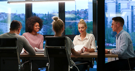 Image showing Multiethnic startup business team in night office