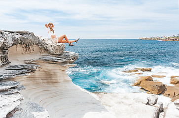 Image showing Smiling female, happy days basking in the summer sunshine by the coast