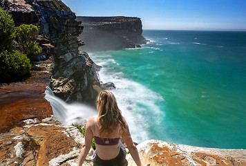 Image showing Watching waterfalls flow into the ocean