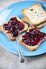 Image showing Fresh toasted cereal bread slices with homemade wild berries jam