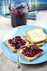 Image showing Toasted cereal bread slices on blue ceramic plate and homemade w