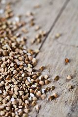 Image showing Fresh green dry buckwheat seads closeup on rustic wooden backgro