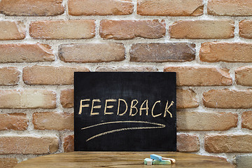 Image showing Chalk board with the word FEEDBACK drown by hand and chalks on w