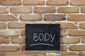 Image showing Chalk board with the word BODY drown by hand and chalks on woode