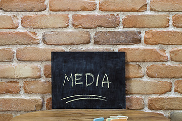 Image showing Chalk board with the word MEDIA drown by hand and chalks on wood