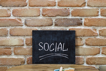 Image showing Chalk board with the word SOCIAL drown by hand and chalks on woo