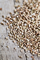 Image showing Fresh green dry buckwheat seads closeup on rustic wooden backgro