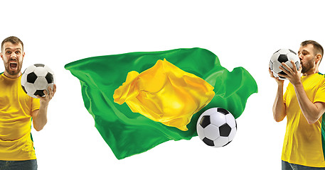 Image showing Brazilian fan celebrating on white background. The young man in soccer football uniform with ball standing at white studio. Fan, support concept. Human emotions concept.