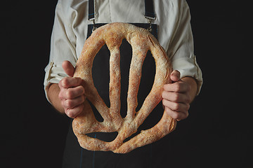 Image showing Baker\'s hands hold fougas bread