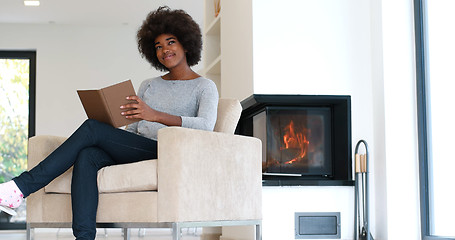 Image showing black woman at home reading book