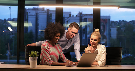 Image showing Multiethnic startup business team in night office