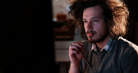 Image showing man working on computer in dark office