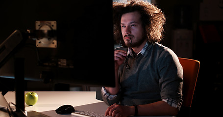 Image showing man working on computer in dark office