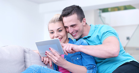 Image showing couple relaxing at  home with tablet computers