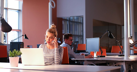 Image showing businesswoman using a laptop in startup office