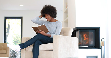 Image showing black woman at home reading book