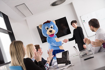 Image showing boss dresed as bear having fun with business people in trendy of