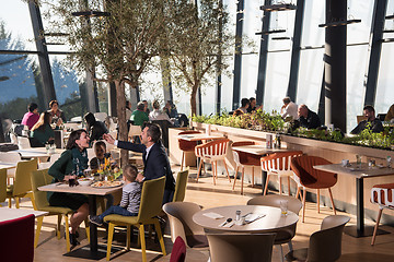 Image showing Young parents enjoying lunch time with their children