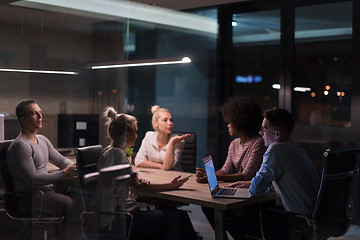 Image showing Multiethnic startup business team in night office