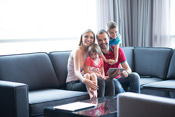 Image showing happy young couple spending time with kids