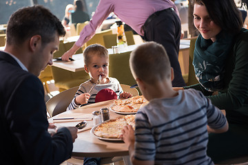 Image showing Young parents enjoying lunch time with their children