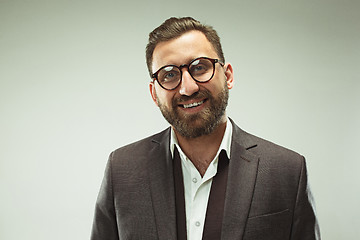 Image showing The happy business man standing and smiling against pastel background.