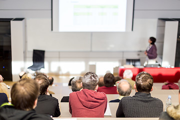 Image showing Woman giving academic presentation in lecture hall at university.