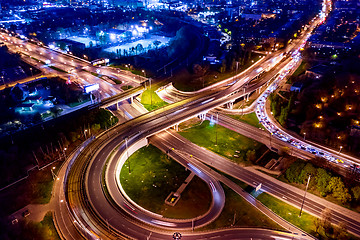 Image showing Night Aerial view of a freeway intersection traffic trails in ni