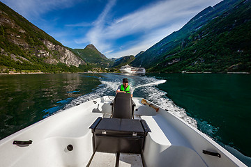 Image showing Man driving a motor boat. Geiranger fjord, Beautiful Nature Norw