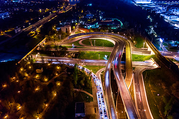 Image showing Night Aerial view of a freeway intersection traffic trails in ni