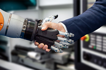 Image showing Hand of a businessman shaking hands with a Android robot.