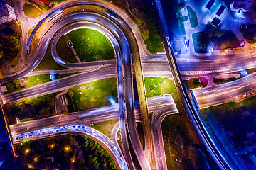 Image showing Night Aerial view of a freeway intersection traffic trails in ni