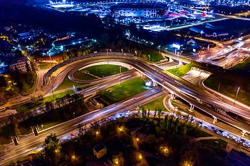 Image showing Night Aerial view of a freeway intersection traffic trails in ni