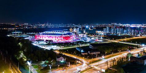 Image showing Night Aerial view of a freeway intersection and football stadium