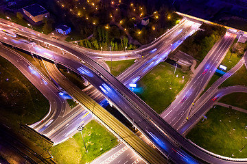 Image showing Night Aerial view of a freeway intersection traffic trails in ni