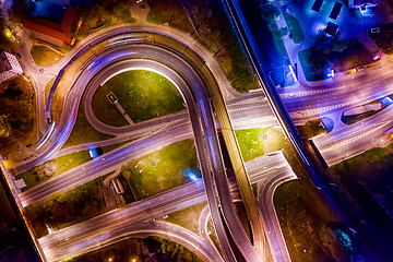 Image showing Night Aerial view of a freeway intersection traffic trails in ni