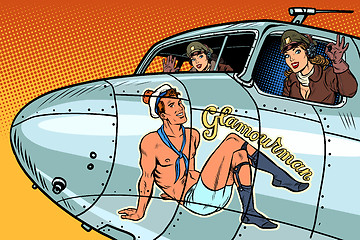 Image showing women pilots girls. Pinup man on the fuselage of a retro bomber