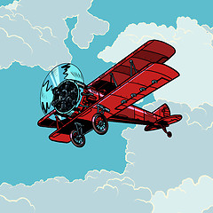 Image showing retro biplane plane flying in the clouds