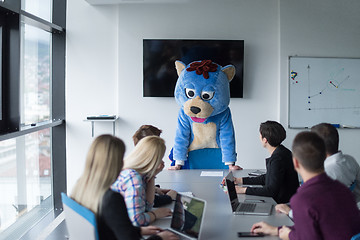 Image showing boss dresed as bear having fun with business people in trendy of