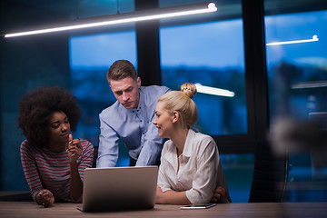 Image showing Multiethnic startup business team in night office