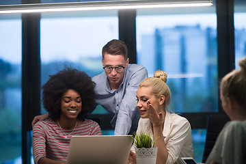 Image showing Multiethnic startup business team in night office