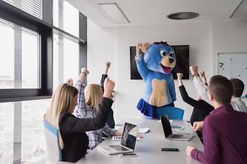 Image showing boss dresed as bear having fun with business people in trendy of