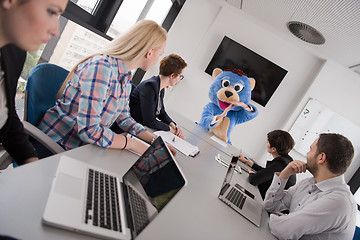 Image showing boss dresed as bear having fun with business people in trendy of