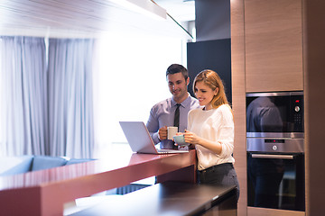 Image showing A young couple is preparing for a job and using a laptop