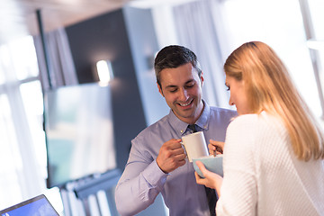 Image showing A young couple is preparing for a job and using a laptop