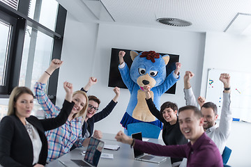 Image showing boss dresed as bear having fun with business people in trendy of