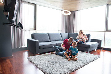 Image showing Happy family playing a video game