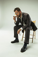 Image showing The barded man in a suit holding cigar