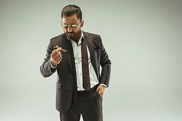 Image showing The barded man in a suit holding cigar