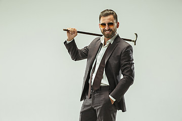 Image showing The barded man in a suit holding cane.